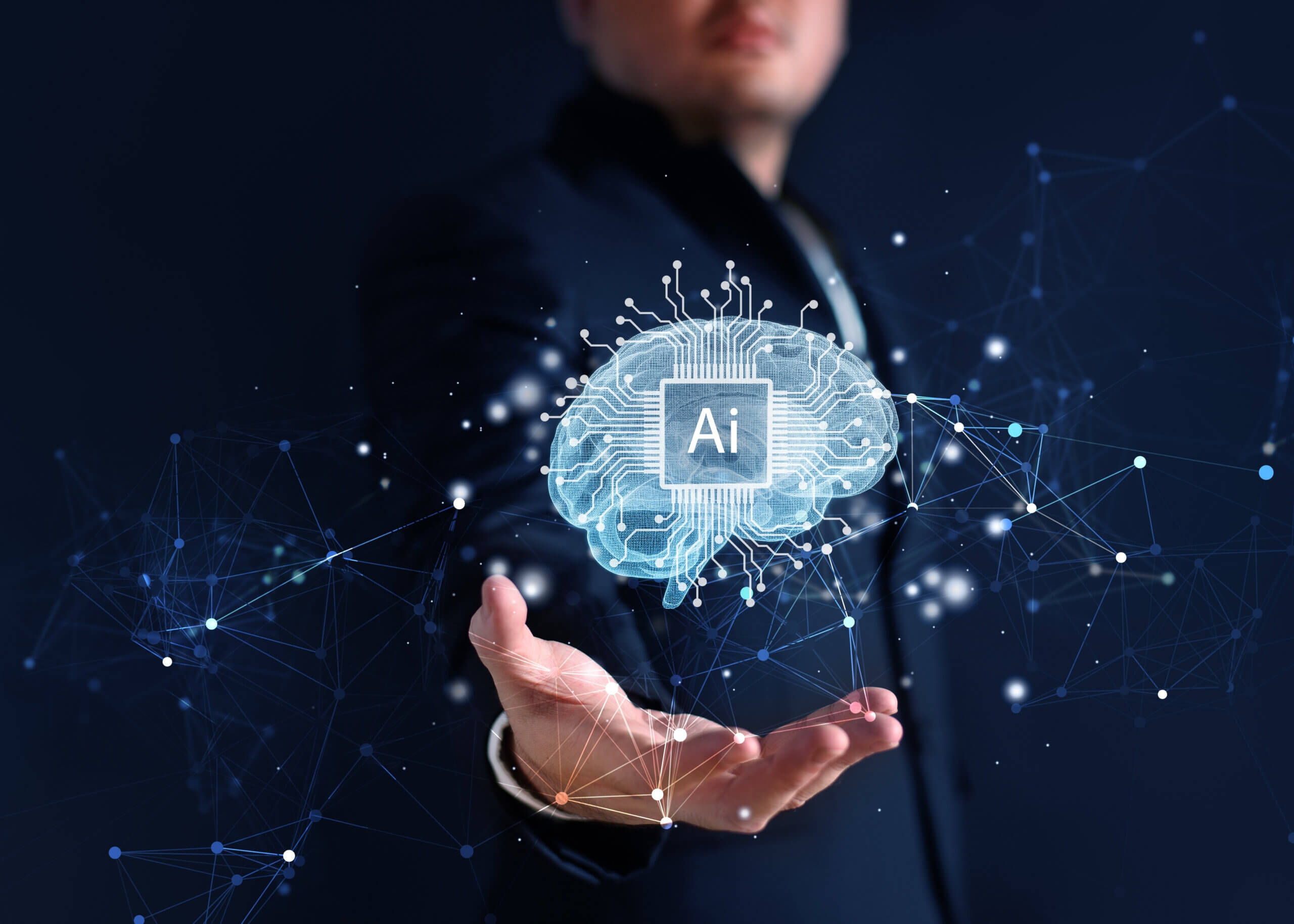 Man holding a transparent brain with 'AI' written on it.